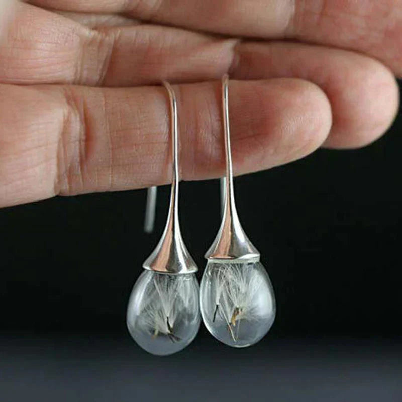 Boucles d'oreilles avec pendentif en dent de lion argenté